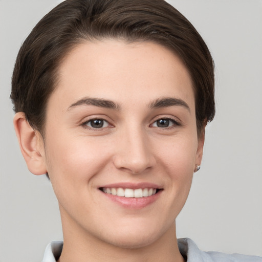 Joyful white young-adult female with short  brown hair and brown eyes