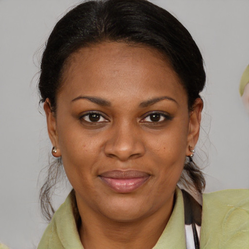 Joyful black adult female with medium  brown hair and brown eyes