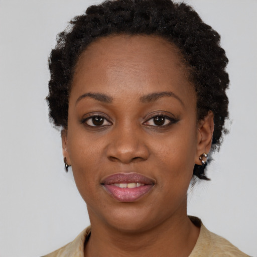 Joyful black adult female with short  brown hair and brown eyes