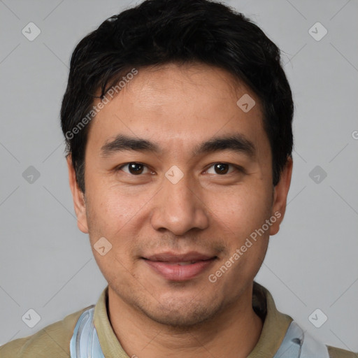 Joyful white young-adult male with short  black hair and brown eyes