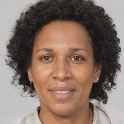 Joyful black adult female with short  brown hair and brown eyes
