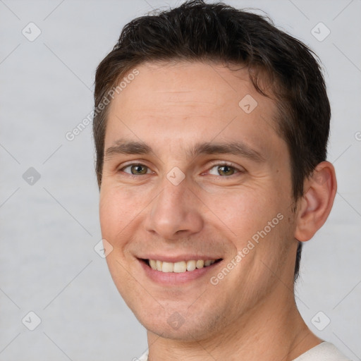 Joyful white adult male with short  brown hair and brown eyes