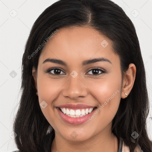 Joyful latino young-adult female with long  brown hair and brown eyes