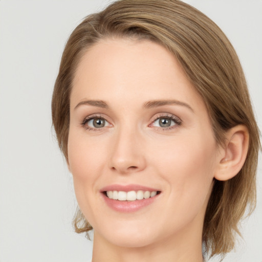 Joyful white young-adult female with long  brown hair and green eyes