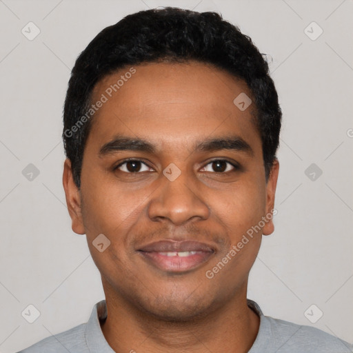 Joyful black young-adult male with short  black hair and brown eyes