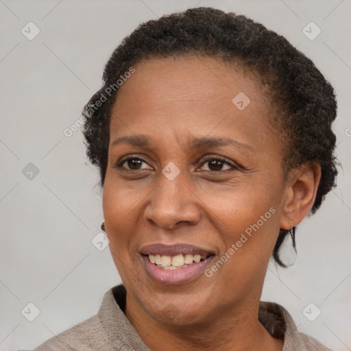 Joyful black adult female with short  brown hair and brown eyes