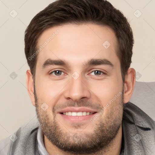 Joyful white young-adult male with short  brown hair and brown eyes