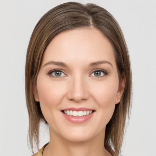 Joyful white young-adult female with medium  brown hair and grey eyes