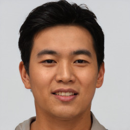 Joyful asian young-adult male with short  brown hair and brown eyes