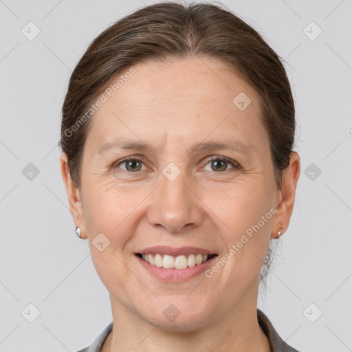 Joyful white adult female with short  brown hair and grey eyes