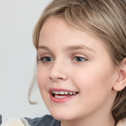 Joyful white child female with medium  brown hair and blue eyes