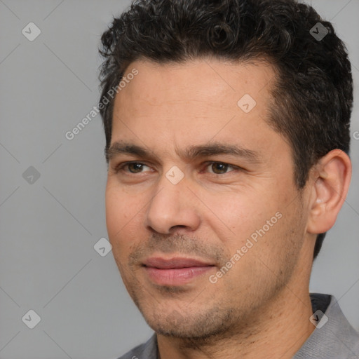 Joyful white adult male with short  black hair and brown eyes