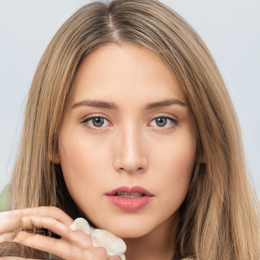 Neutral white young-adult female with long  brown hair and brown eyes