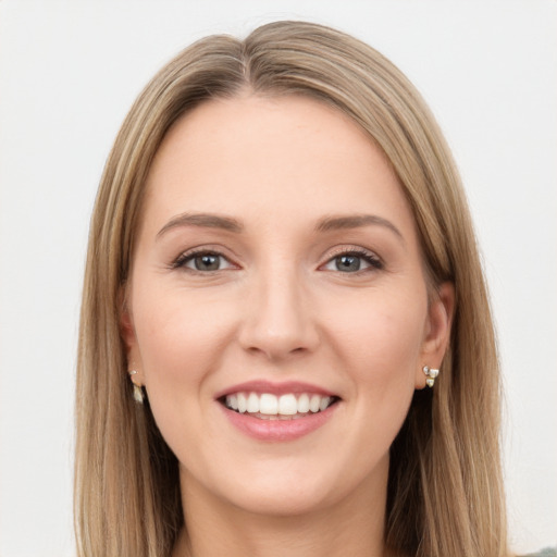 Joyful white young-adult female with long  brown hair and green eyes