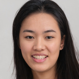 Joyful asian young-adult female with long  brown hair and brown eyes