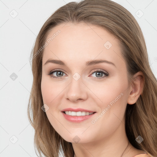 Joyful white young-adult female with long  brown hair and blue eyes