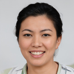 Joyful asian young-adult female with short  brown hair and brown eyes