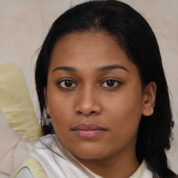 Joyful black young-adult female with medium  brown hair and brown eyes