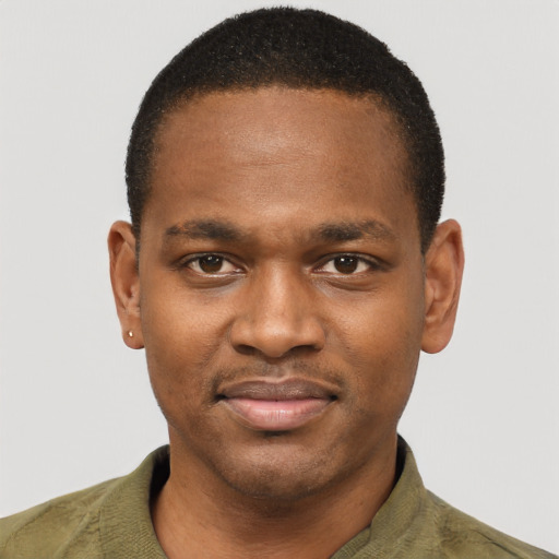 Joyful latino young-adult male with short  brown hair and brown eyes