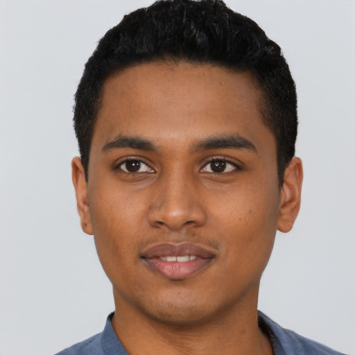Joyful black young-adult male with short  black hair and brown eyes