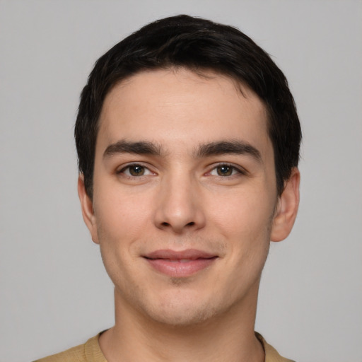 Joyful white young-adult male with short  black hair and brown eyes