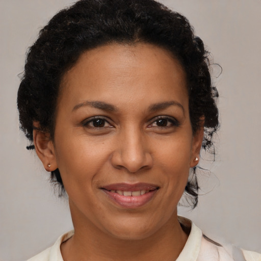 Joyful black adult female with short  brown hair and brown eyes