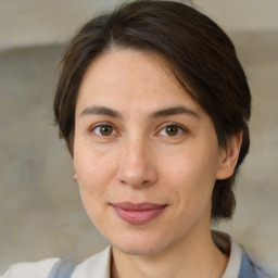 Joyful white adult female with medium  brown hair and brown eyes