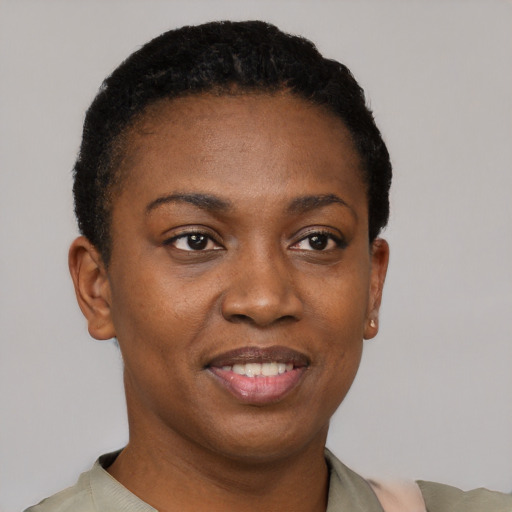 Joyful black young-adult female with short  black hair and brown eyes