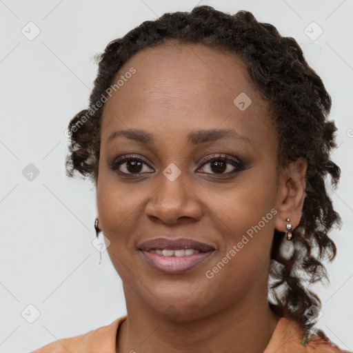 Joyful black young-adult female with medium  brown hair and brown eyes