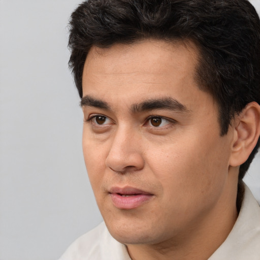 Joyful white young-adult male with short  black hair and brown eyes