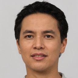 Joyful asian adult male with short  black hair and brown eyes