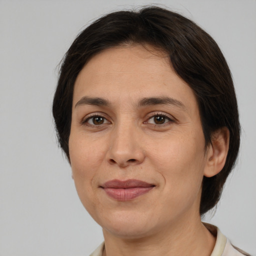 Joyful white adult female with medium  brown hair and brown eyes