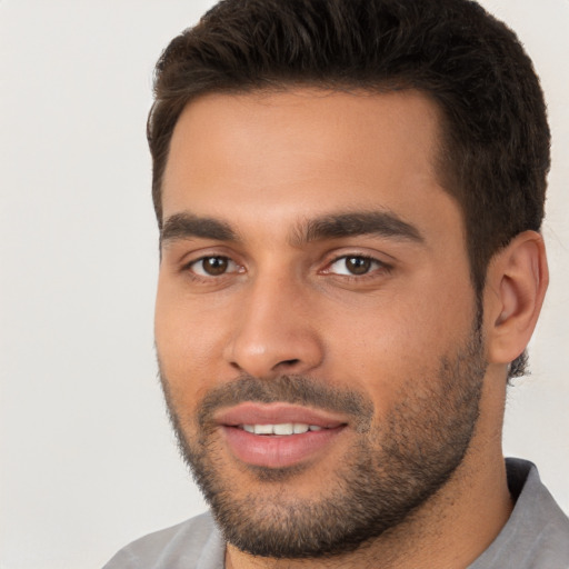 Joyful white young-adult male with short  brown hair and brown eyes