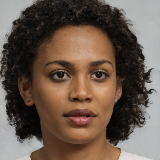 Neutral black young-adult female with medium  brown hair and brown eyes
