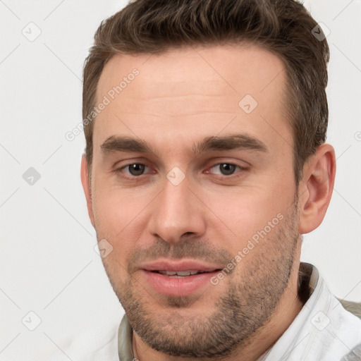 Joyful white young-adult male with short  brown hair and brown eyes