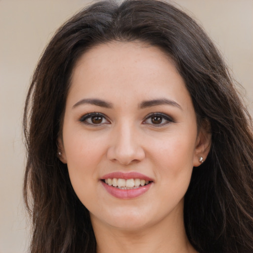 Joyful white young-adult female with long  brown hair and brown eyes