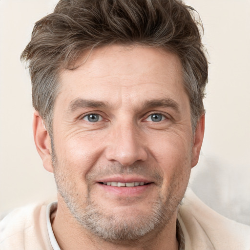 Joyful white adult male with short  brown hair and grey eyes