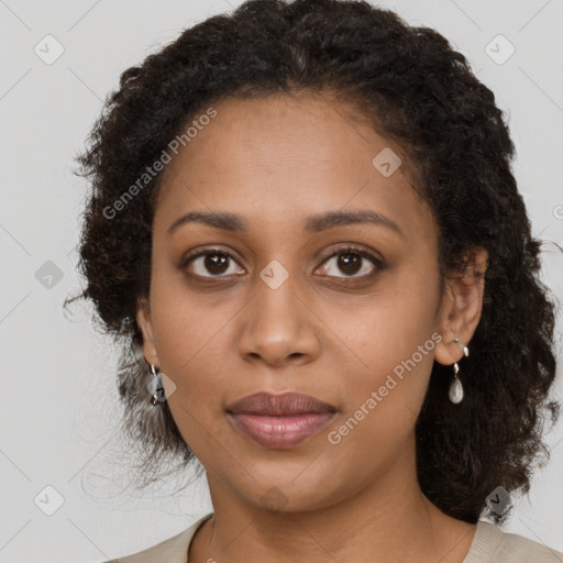 Joyful black young-adult female with medium  brown hair and brown eyes