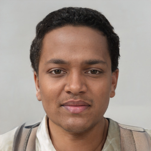 Joyful black young-adult male with short  black hair and brown eyes