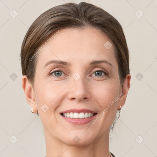 Joyful white young-adult female with short  brown hair and grey eyes