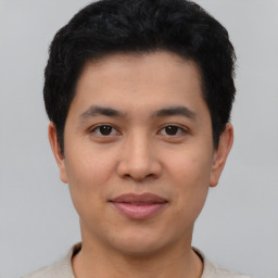 Joyful asian young-adult male with short  black hair and brown eyes