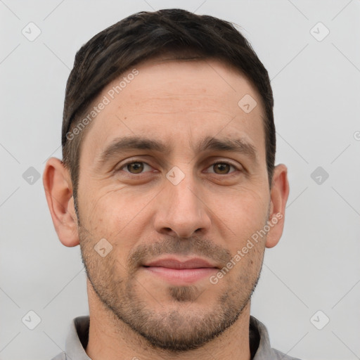 Joyful white young-adult male with short  brown hair and grey eyes