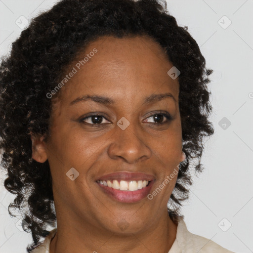 Joyful black adult female with medium  brown hair and brown eyes