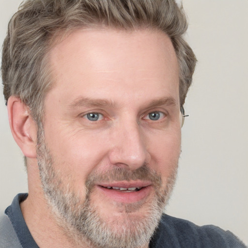 Joyful white adult male with short  brown hair and grey eyes