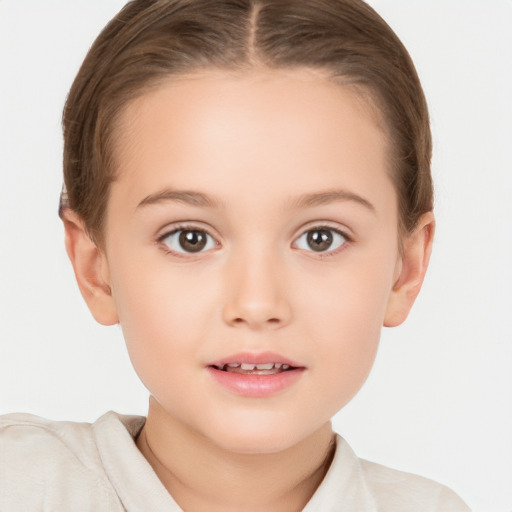 Joyful white child female with short  brown hair and brown eyes