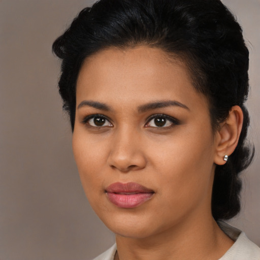 Joyful latino young-adult female with medium  brown hair and brown eyes