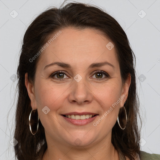 Joyful white adult female with long  brown hair and grey eyes