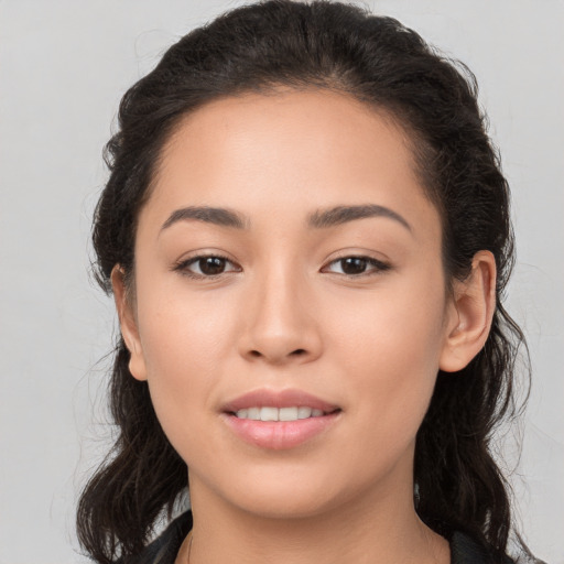 Joyful white young-adult female with long  brown hair and brown eyes