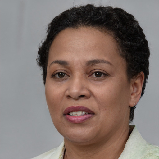 Joyful latino adult female with short  brown hair and brown eyes