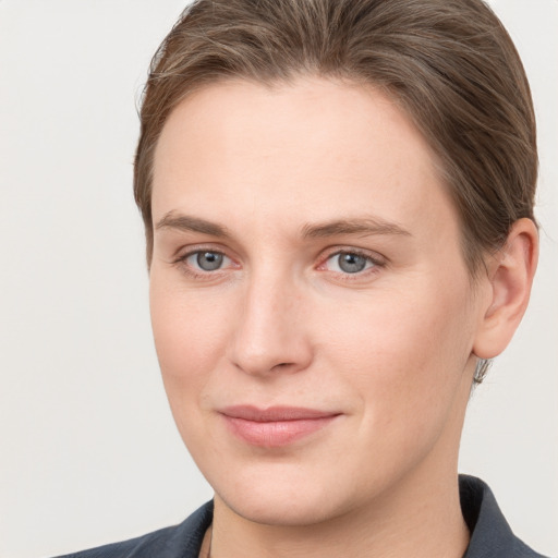 Joyful white young-adult female with short  brown hair and grey eyes